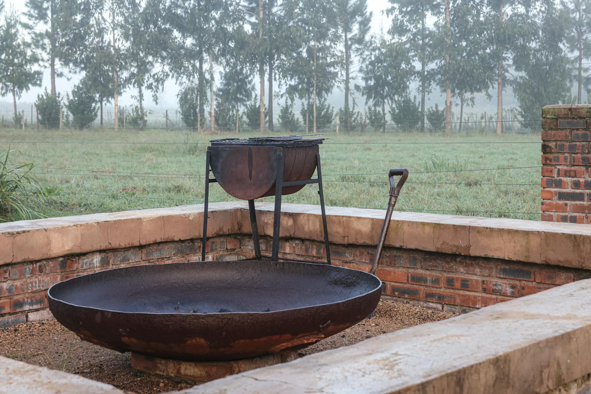 Mgliste poranne ujęcie ceglanego paleniska w ogrodzie